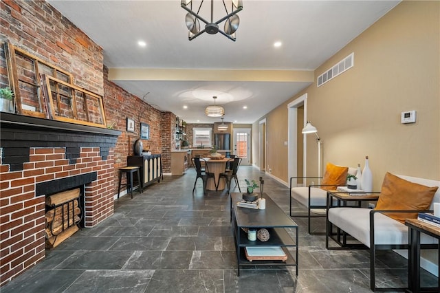 living area featuring a brick fireplace, a chandelier, baseboards, and recessed lighting