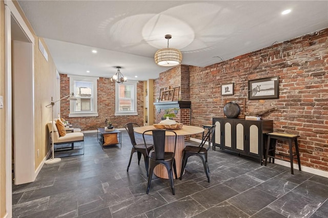 dining space with baseboards, brick wall, and recessed lighting