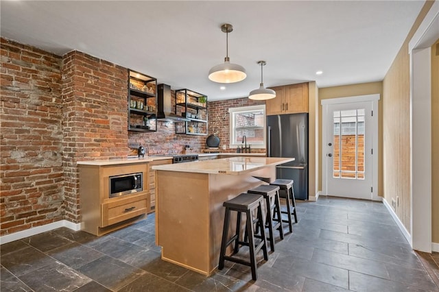 kitchen featuring appliances with stainless steel finishes, wall chimney range hood, baseboards, open shelves, and a kitchen island
