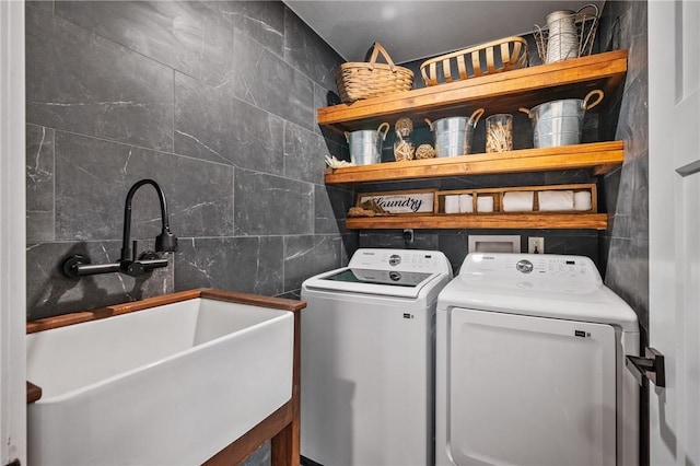 clothes washing area with washer and clothes dryer