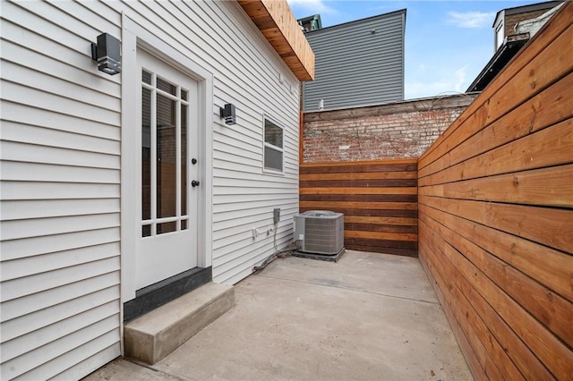 view of patio / terrace with central AC, entry steps, and fence