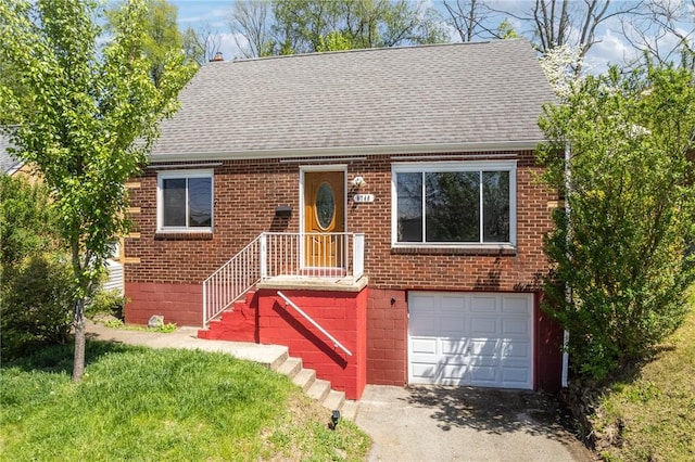view of front of property featuring a shingled roof, an attached garage, aphalt driveway, and brick siding