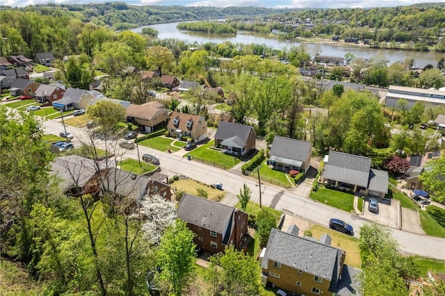 birds eye view of property featuring a residential view, a water view, and a forest view