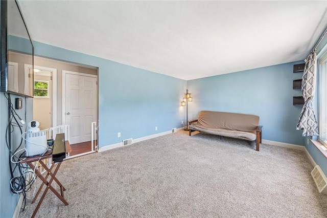sitting room with carpet floors, baseboards, and visible vents