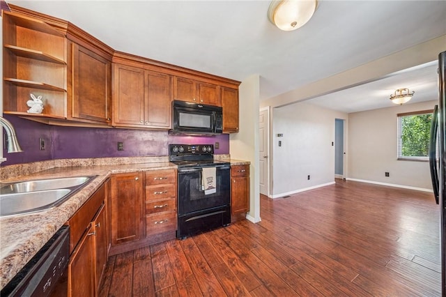 kitchen with a sink, baseboards, black appliances, and dark wood-style floors