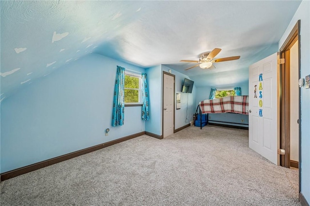 carpeted bedroom featuring a ceiling fan, baseboards, and lofted ceiling