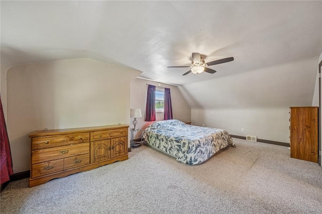 carpeted bedroom with a ceiling fan, baseboards, visible vents, and vaulted ceiling