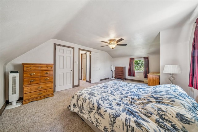 carpeted bedroom with a ceiling fan, baseboards, heating unit, and vaulted ceiling