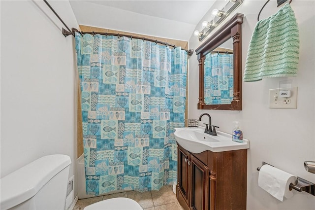 bathroom with vanity, tile patterned floors, and toilet
