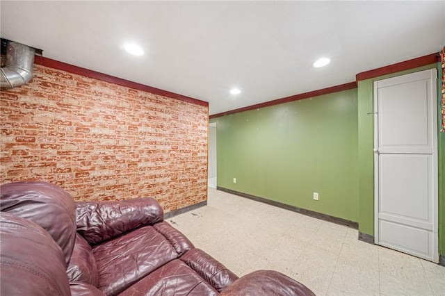 living area with brick wall, baseboards, light floors, ornamental molding, and recessed lighting