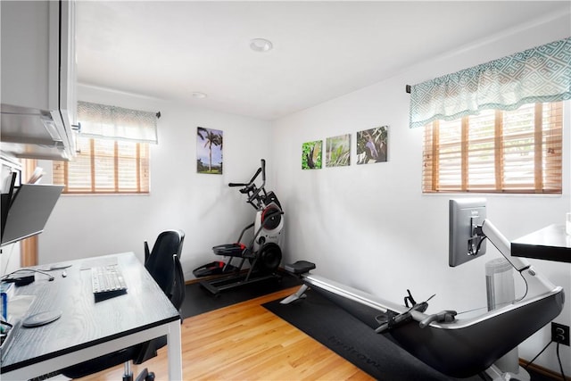exercise area with light wood-style floors