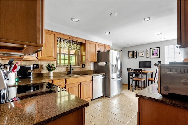 kitchen with a toaster, recessed lighting, tasteful backsplash, a sink, and stainless steel appliances