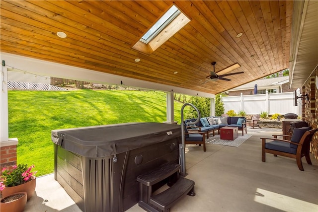 view of patio featuring an outdoor living space, fence, a ceiling fan, and a hot tub