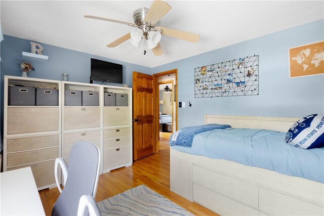 bedroom featuring a ceiling fan and wood finished floors
