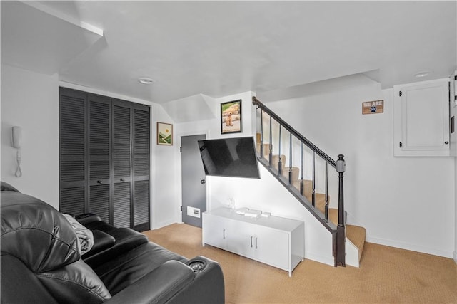 living area featuring stairway, carpet floors, and baseboards