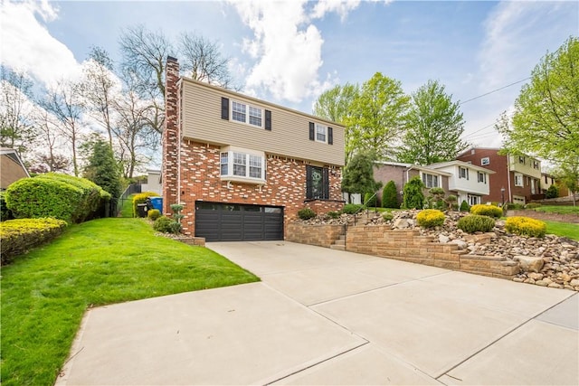 colonial house with a chimney, brick siding, a front lawn, concrete driveway, and an attached garage