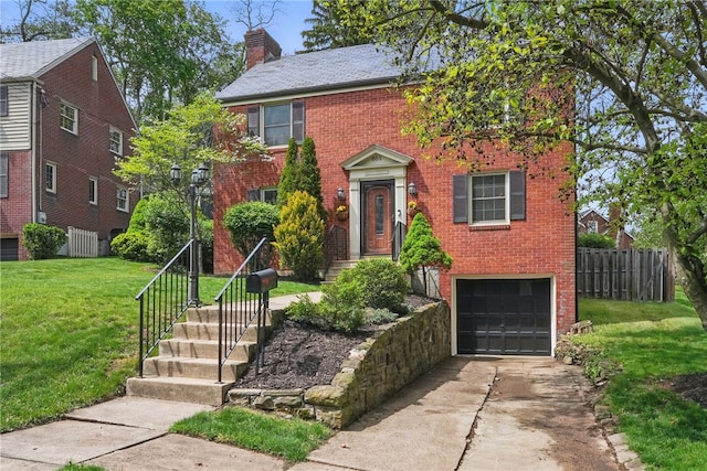 colonial home featuring fence, a chimney, brick siding, concrete driveway, and an attached garage