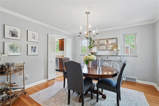 dining space with visible vents, ornamental molding, baseboards, and a chandelier