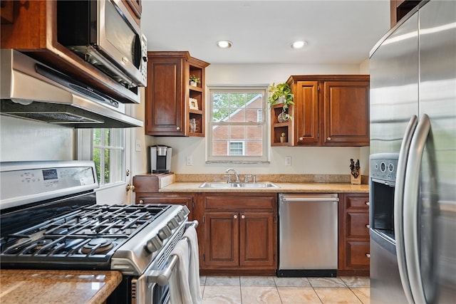 kitchen featuring open shelves, a sink, light countertops, light tile patterned floors, and stainless steel appliances