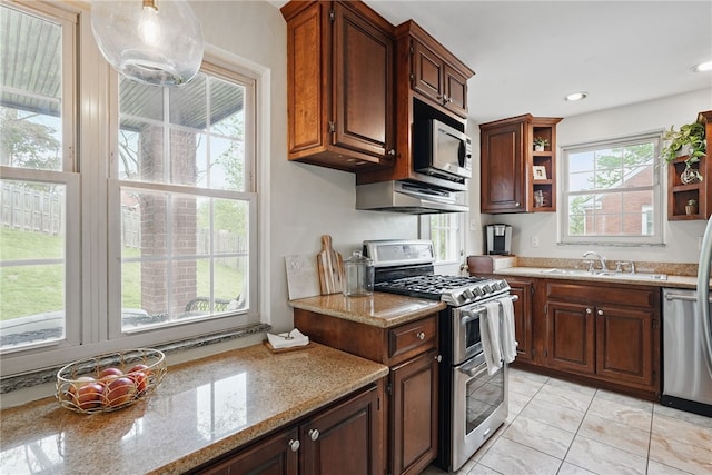 kitchen with open shelves, under cabinet range hood, light stone counters, a sink, and stainless steel appliances