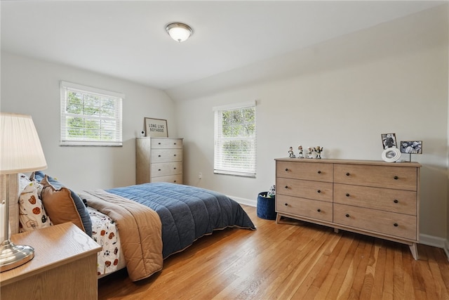 bedroom featuring baseboards and light wood finished floors