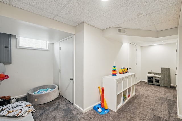 game room featuring carpet floors, a paneled ceiling, baseboards, visible vents, and electric panel