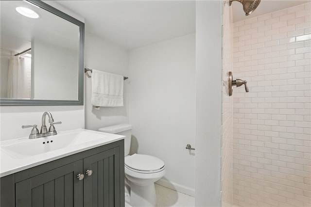 bathroom featuring toilet, a shower stall, and vanity