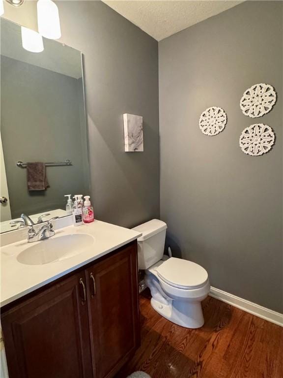 2001 Trillium Ct, North Strabane, PA 15317 - half bath with a textured ceiling, wood finished floors, vanity, baseboards, and toilet