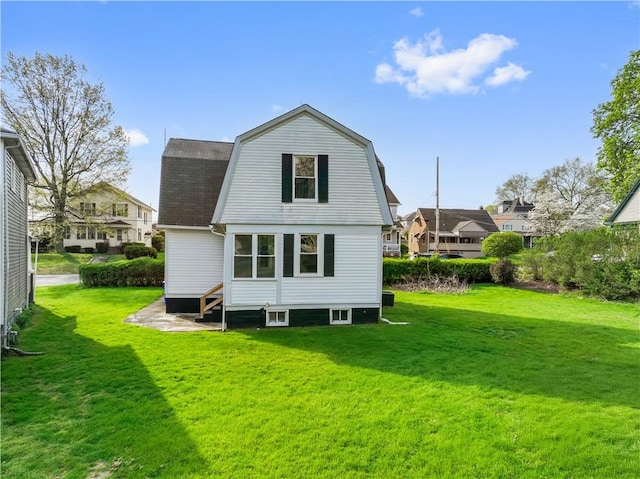 848 Ohio Ave, Monaca, PA 15061 - back of property featuring a gambrel roof, a yard, a residential view, and a shingled roof