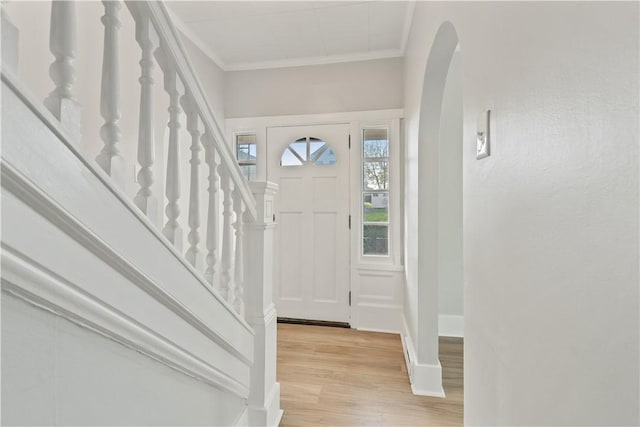 848 Ohio Ave, Monaca, PA 15061 - foyer entrance featuring crown molding, arched walkways, stairs, and light wood-style flooring