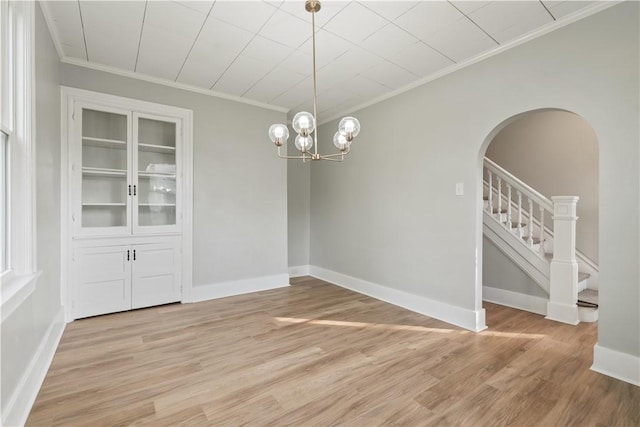 848 Ohio Ave, Monaca, PA 15061 - unfurnished dining area featuring arched walkways, a notable chandelier, ornamental molding, and light wood-style floors