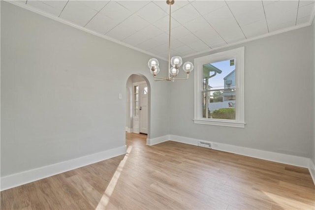 848 Ohio Ave, Monaca, PA 15061 - unfurnished dining area featuring light wood-style floors, arched walkways, ornamental molding, and a chandelier