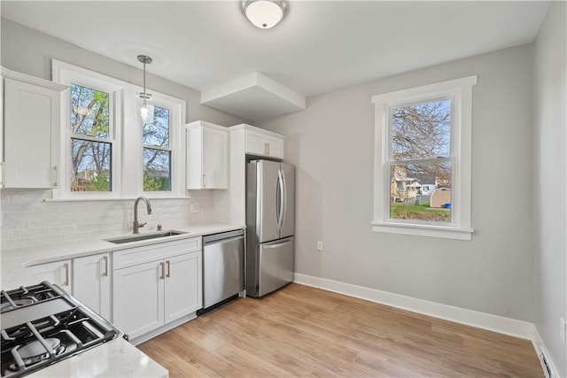 848 Ohio Ave, Monaca, PA 15061 - kitchen featuring white cabinets, stainless steel appliances, a sink, and backsplash