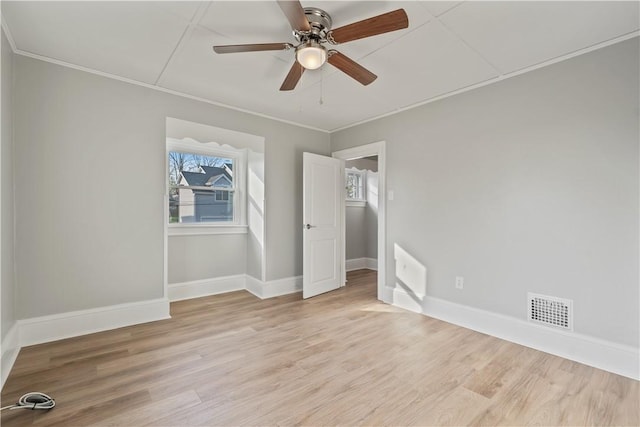 848 Ohio Ave, Monaca, PA 15061 - unfurnished bedroom featuring a ceiling fan, visible vents, crown molding, baseboards, and light wood finished floors