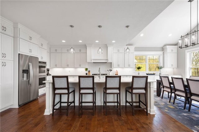 kitchen featuring light countertops, appliances with stainless steel finishes, backsplash, and white cabinetry