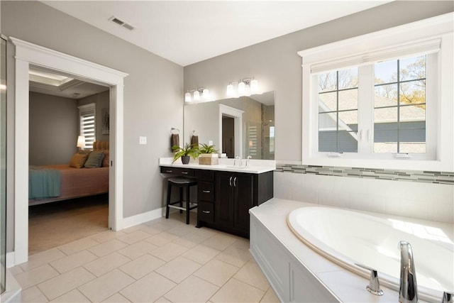 ensuite bathroom featuring a bath, visible vents, tile patterned floors, vanity, and ensuite bath