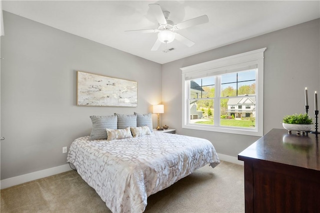 bedroom featuring baseboards, ceiling fan, carpet flooring, and visible vents