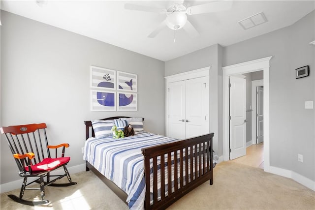 carpeted bedroom with visible vents, baseboards, ceiling fan, and a closet