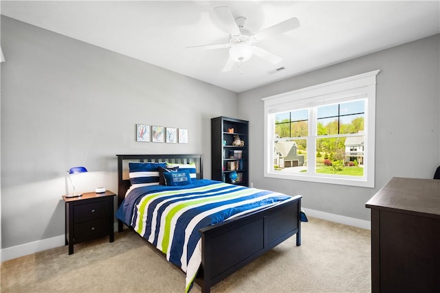 carpeted bedroom featuring a ceiling fan, baseboards, and visible vents