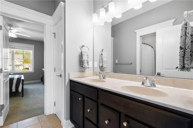 bathroom with a sink, tile patterned floors, a ceiling fan, and double vanity