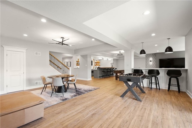 interior space featuring baseboards, wood finished floors, and visible vents