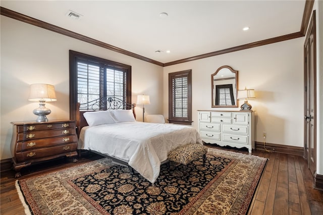 bedroom with dark wood-style floors, baseboards, visible vents, and multiple windows