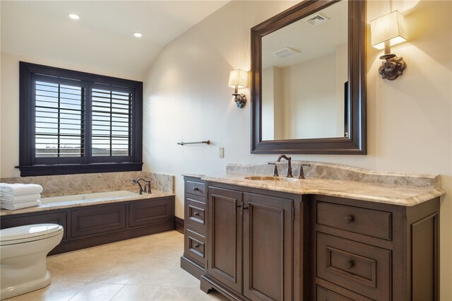bathroom with visible vents, a garden tub, vanity, lofted ceiling, and toilet