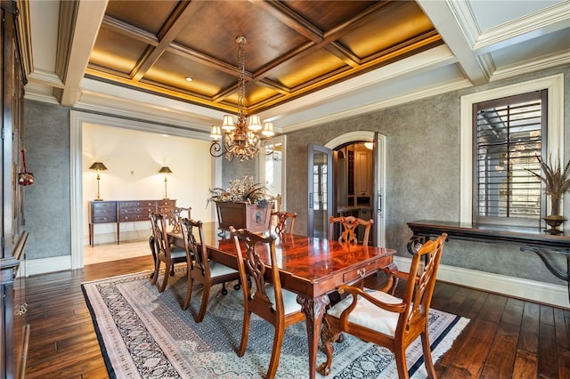 dining room with arched walkways, coffered ceiling, and dark wood-style floors