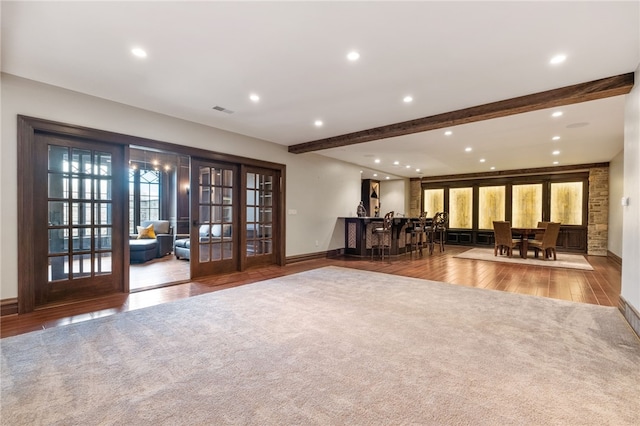 interior space featuring recessed lighting, beam ceiling, french doors, and wood finished floors