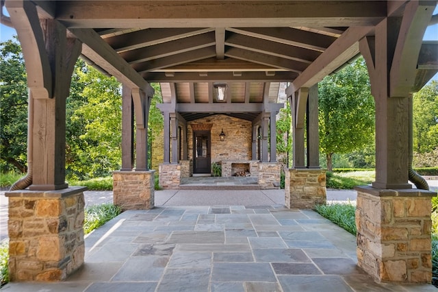 view of patio with an outdoor stone fireplace