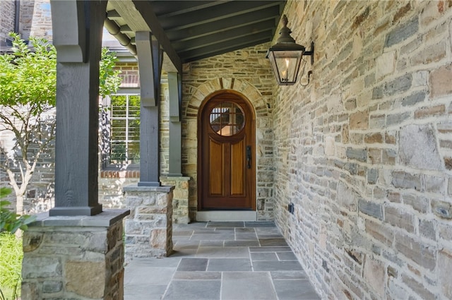 doorway to property featuring stone siding