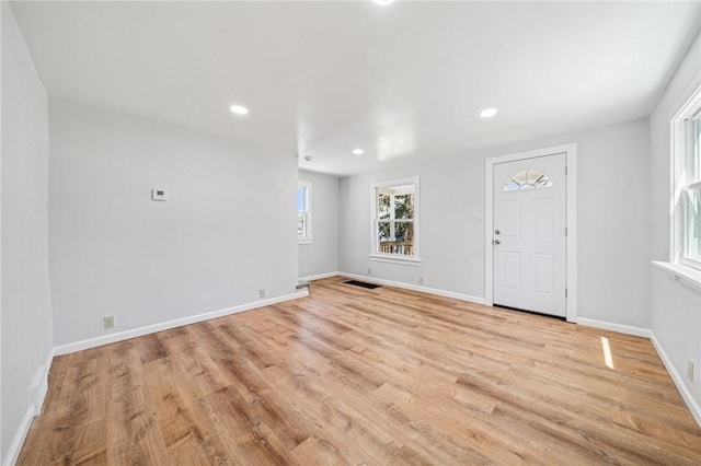 interior space featuring baseboards, recessed lighting, light wood-style flooring, and visible vents
