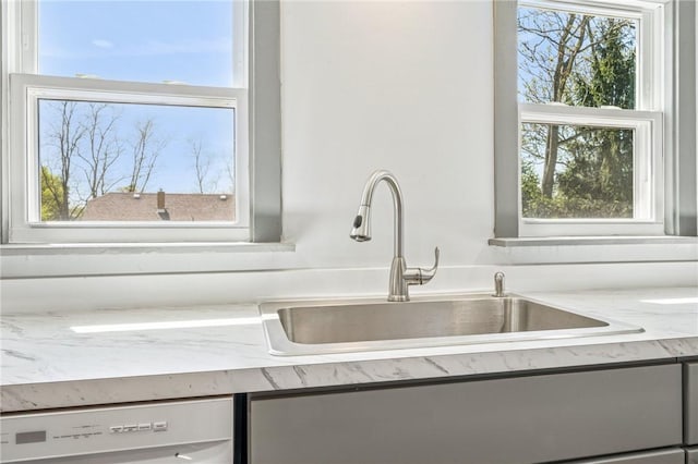 interior details featuring a sink and white dishwasher