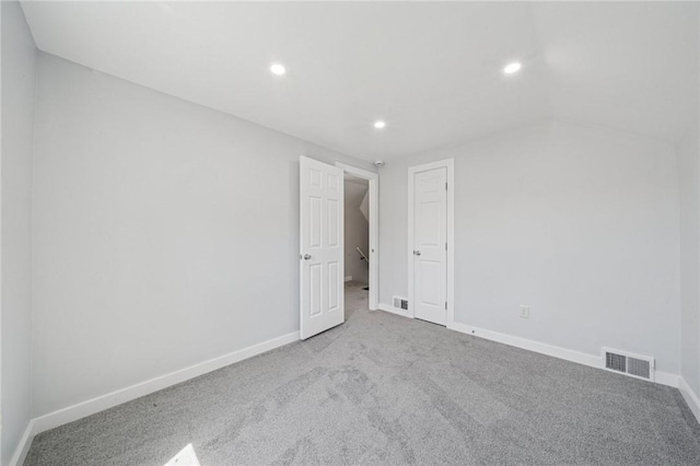 spare room with visible vents, recessed lighting, carpet, and baseboards